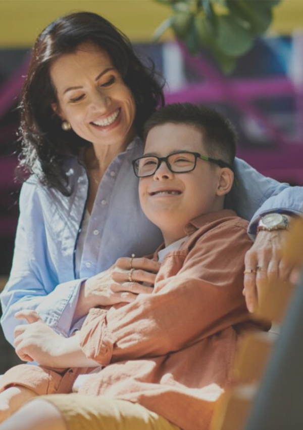 A QCare support worker helping a client at home